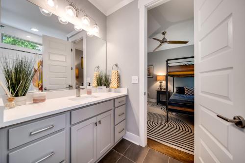 a bathroom with two sinks and a mirror at Beaus Oasis - 3 Miles To Dtwn Nashville in Nashville