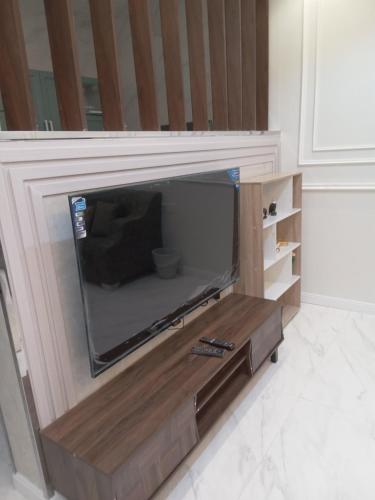 a entertainment center with a tv in a wall at شاليه لوسيل in Khamis Mushayt