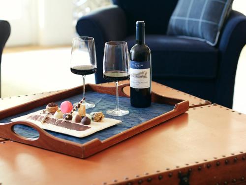 a tray with a bottle of wine and glasses on a table at Boar's Head Resort in Charlottesville