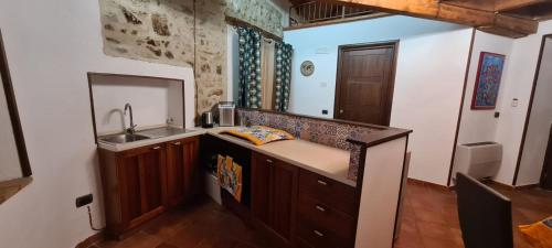 a kitchen with a sink and a counter top at IL BORGO DEL BENESSERE in Rocca Imperiale