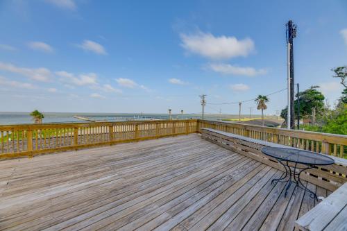 a wooden deck with a table and bench on the beach at Rockport Unit with Pools and Boat Ramp - Near Beaches! in Rockport