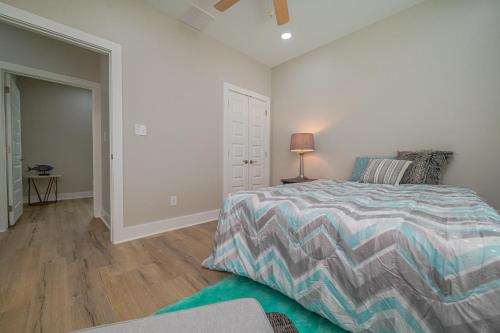 a bedroom with a bed and a chair and a lamp at The Oasis Resort in Rockport