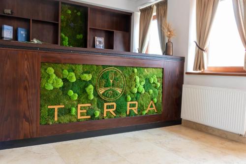 a green wall with the word temra in a room at TERRA penzión in Jasová