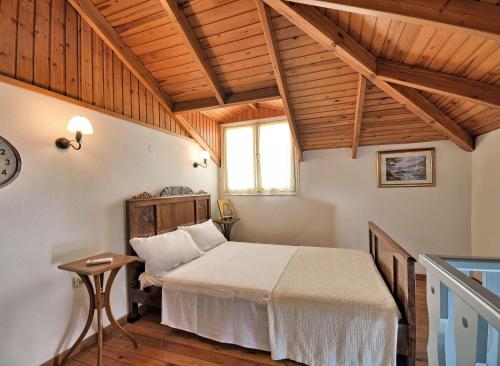 a bedroom with a bed in a room with wooden ceilings at Casa Di Rodi in Rhodes Town