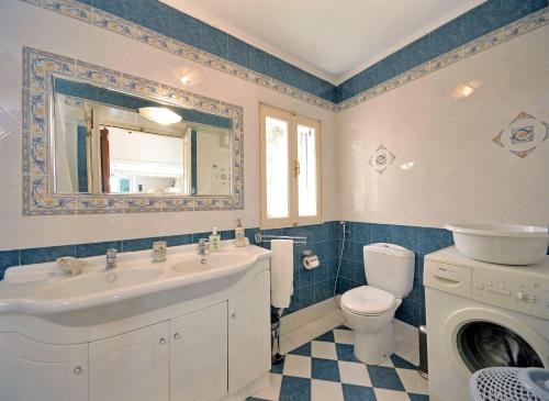 a bathroom with a sink and a toilet and a washing machine at Casa Di Rodi in Rhodes Town