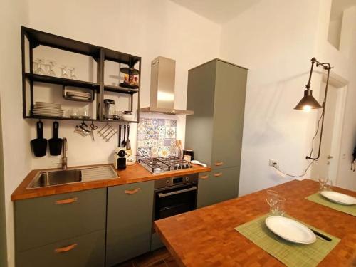 a kitchen with a counter and a sink and a table at Appartamento Olivo in Collecorvino