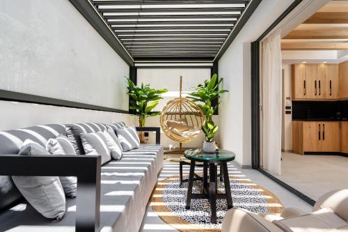 a living room with a couch and a table at Legato Spa Suites in Naxos Chora