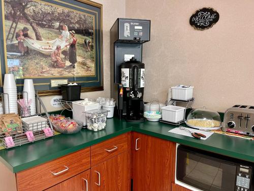 a kitchen counter with a coffee maker and food on it at Brookshire Inn in Inez