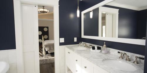 a bathroom with two sinks and a mirror at Anchor Inn Boutique Hotel in Put-in-Bay