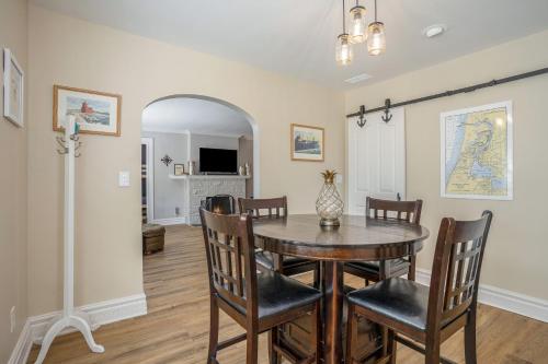 a dining room with a table and chairs at Serenity Now in Saugatuck