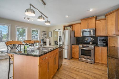 a kitchen with wooden cabinets and stainless steel appliances at Serenity Now in Saugatuck