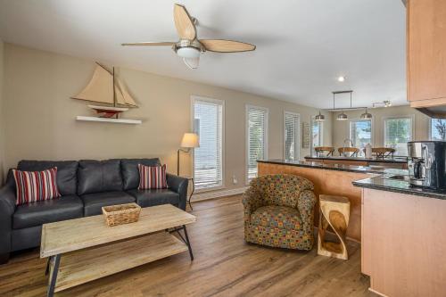 a living room with a couch and a table at Serenity Now in Saugatuck
