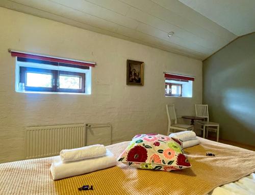 a bedroom with a bed with towels on it at Gasthaus Wiurila in Halikko