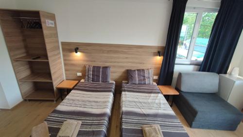 a room with two beds and a couch and a window at Villa Natali in Ohrid