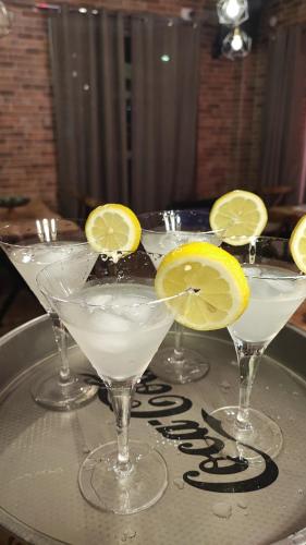 a tray with three martini glasses with lemon slices on it at Villa Natali in Ohrid