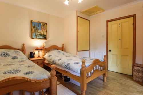 a bedroom with two twin beds and a mirror at Centre Lodge in Lerwick