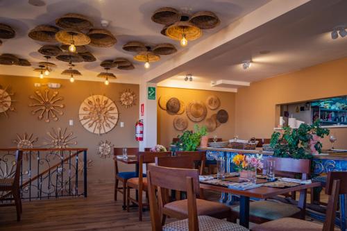 a dining room with tables and chairs in a restaurant at Inkantari Boutique Hotel in Cusco