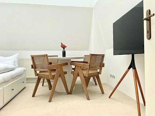 a dining room with a table and two chairs at Apartmá Linda 1880 in Karlovy Vary