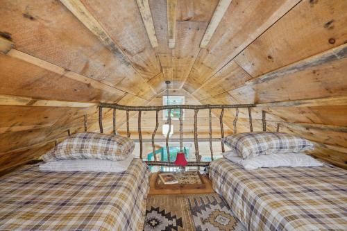 a room with two beds in a log cabin at Gloversville Retreat with Patio and Lake Access! in Gloversville