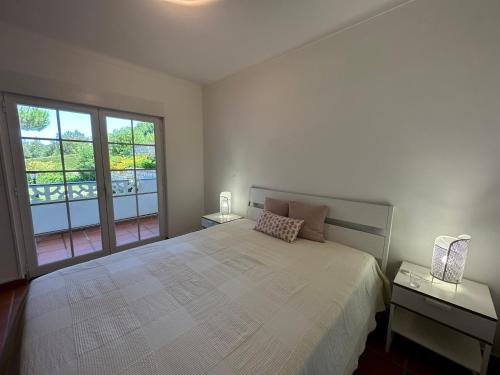 a bedroom with a large bed and a large window at Best Houses 91 - Casa D'el Rey in Amoreira