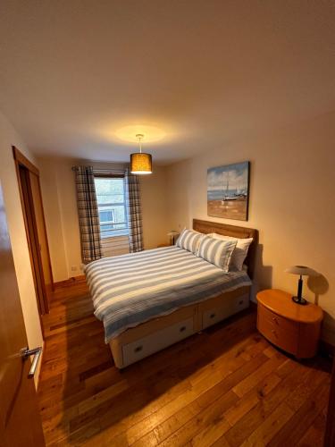 a bedroom with a bed and a window at Metro 8 Inverness City Centre in Inverness