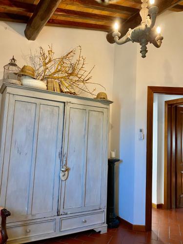 a large wooden cabinet in a room with a ceiling at La Magione dei Todaro in Borgo a Buggiano