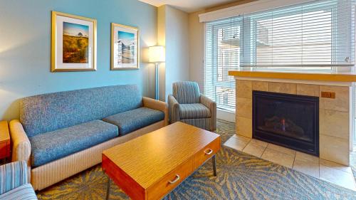 a living room with a couch and a fireplace at WorldMark Seaside by BookTimeShares in Seaside