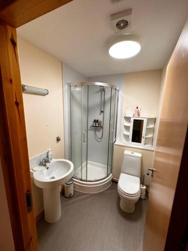 a bathroom with a shower and a toilet and a sink at Metro 8 Inverness City Centre in Inverness