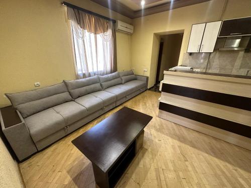 a living room with a couch and a table at Tatev Apartments in Yerevan