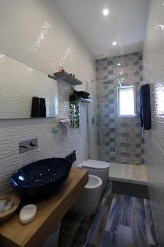 a bathroom with a sink and a toilet at Montebello Luxury Apartment in Peschici