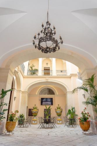 a large hallway with a chandelier in a building at Il Cavaliere al borgo antico in Copertino