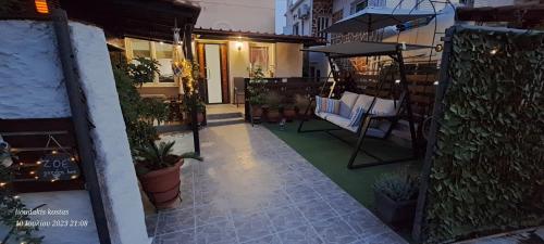an outdoor patio with chairs and plants on a building at Zoe garden home in Spáta