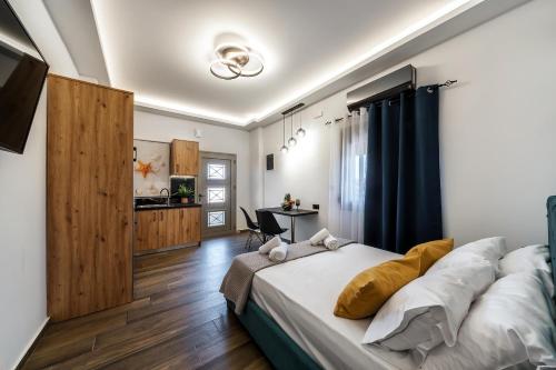 a bedroom with a large bed and a table at Seaside Apartment 1 in Hersonissos