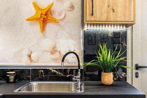 a kitchen sink with a starfish on the wall at Seaside Apartment 1 in Hersonissos