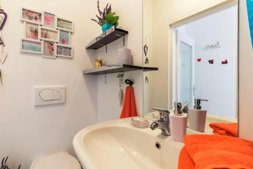 a bathroom with a sink and a mirror at Apartments Chiara mit Meerblick und Pool in Lovran