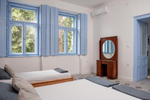 a bedroom with two beds and a mirror at Čuružanka in Čurug