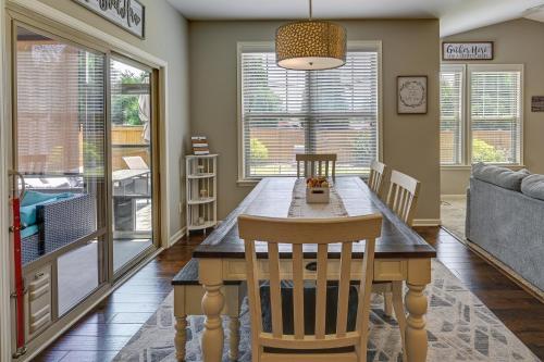 a dining room with a table and chairs and a couch at Cozy South Carolina Retreat with Patio and Fireplace! in Greenville