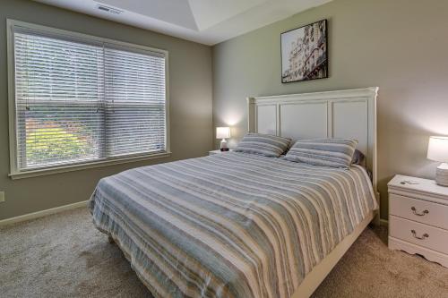 a bedroom with a large bed and a window at Cozy South Carolina Retreat with Patio and Fireplace! in Greenville