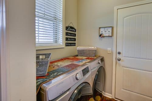a laundry room with a washing machine in a room at Cozy South Carolina Retreat with Patio and Fireplace! in Greenville
