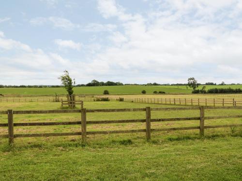 a wooden fence in the middle of a field at The Granary in Morpeth
