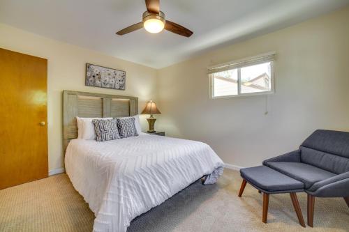 a bedroom with a bed with a ceiling fan and a chair at Carson City Vacation Rental about 19 Mi to Lake Tahoe! in Carson City