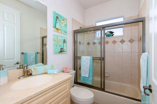 a bathroom with a sink and a shower and a toilet at Villa Bremen - Pool / Spa Home in Cape Coral