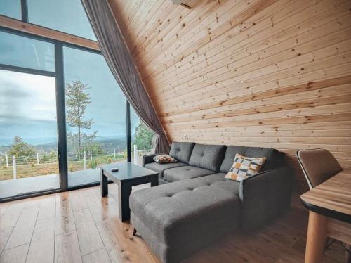a living room with a couch and large windows at Flora-A in Chakvi