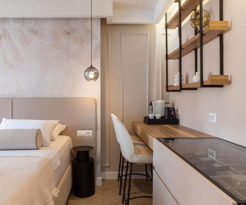 a bedroom with a bed and a kitchen with a table at Le Prestige Luxury Rooms , Self Check-In, Minutes from Split Waterfront in Split