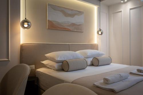 a bedroom with a bed with two pillows on it at Le Prestige Luxury Rooms , Self Check-In, Minutes from Split Waterfront in Split