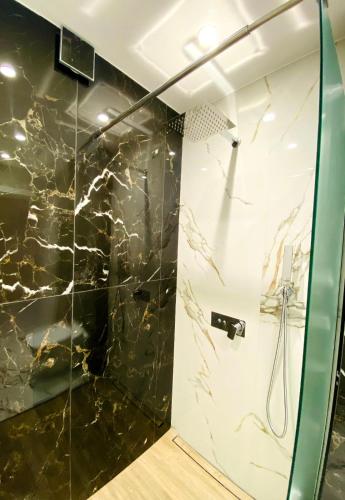 a bathroom with a shower with a glass door at DiP HOME APARTMENTS in Pomorie