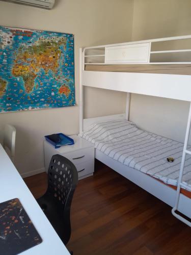 a room with bunk beds with a desk and a chair at Denize Yakın Daire in Antalya