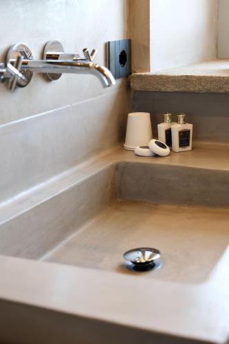 a bathroom sink with a silver faucet at Tenuta Bussia - Wine Relais & Spa in Monforte dʼAlba