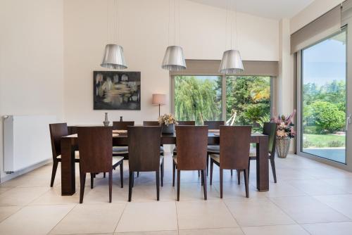 a dining room with a table and chairs at Phillyrėa Luxury Villas in Kos Town