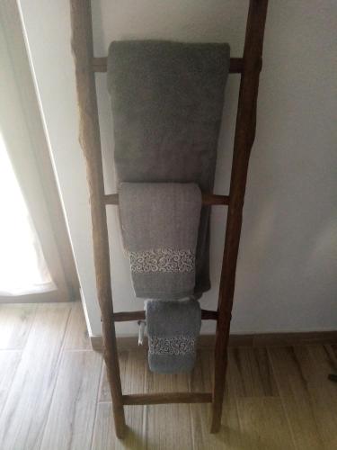 a wooden chair with three towels on it at Casa Andreini in Mombarcaro